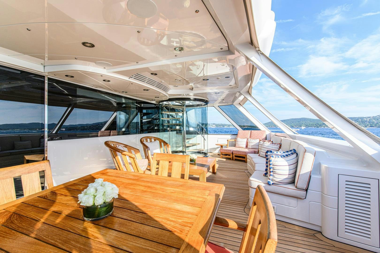 a room with a table and chairs aboard VICTORIA DEL MAR Yacht for Sale