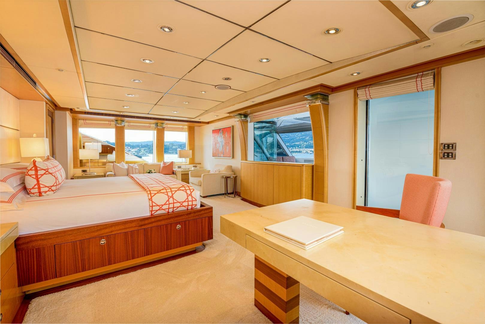 a room with a bed and desk aboard VICTORIA DEL MAR Yacht for Sale