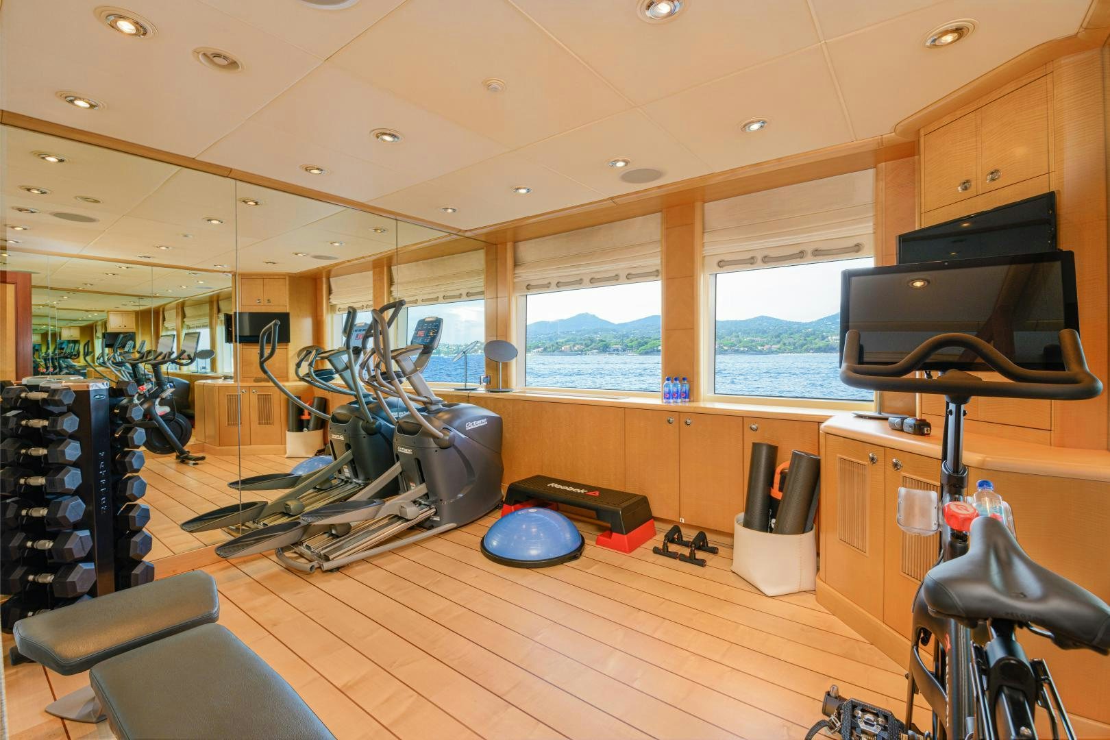 a room with a large window and a wood floor with a large window aboard VICTORIA DEL MAR Yacht for Sale