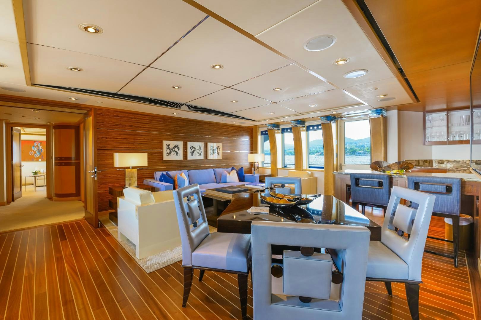 a room with a table chairs and a couch aboard VICTORIA DEL MAR Yacht for Sale