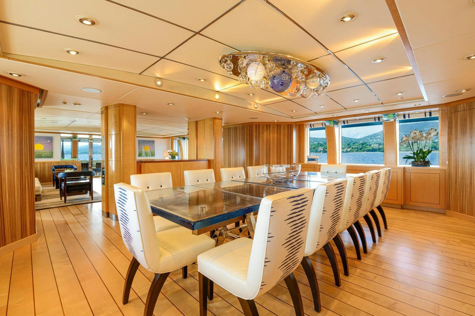a large room with a table and chairs aboard VICTORIA DEL MAR Yacht for Sale