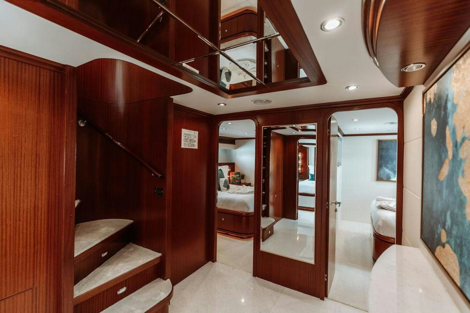 a room with a bed and a mirror aboard BEACHFRONT Yacht for Sale