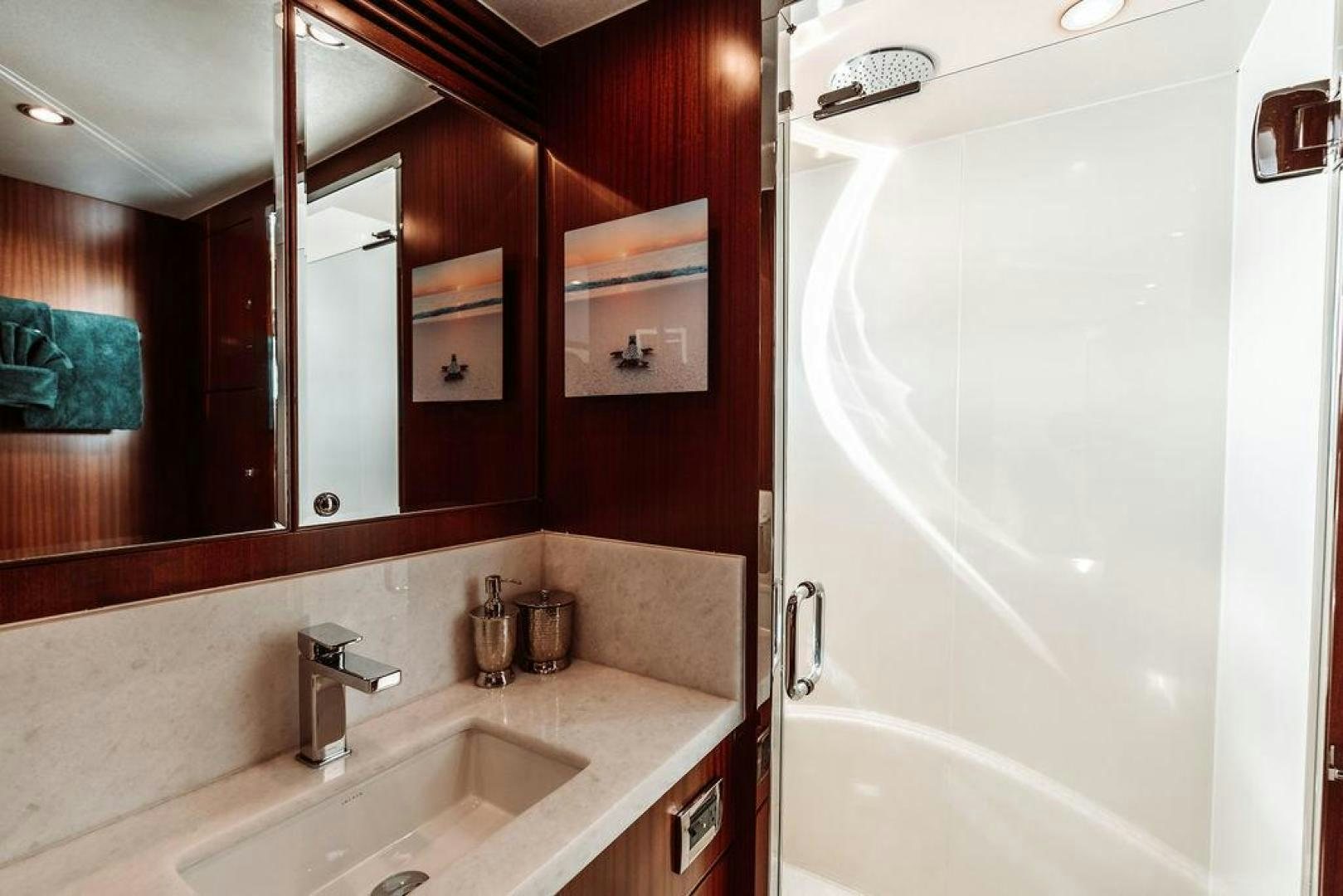 a bathroom with a bathtub sink and a mirror aboard BEACHFRONT Yacht for Sale