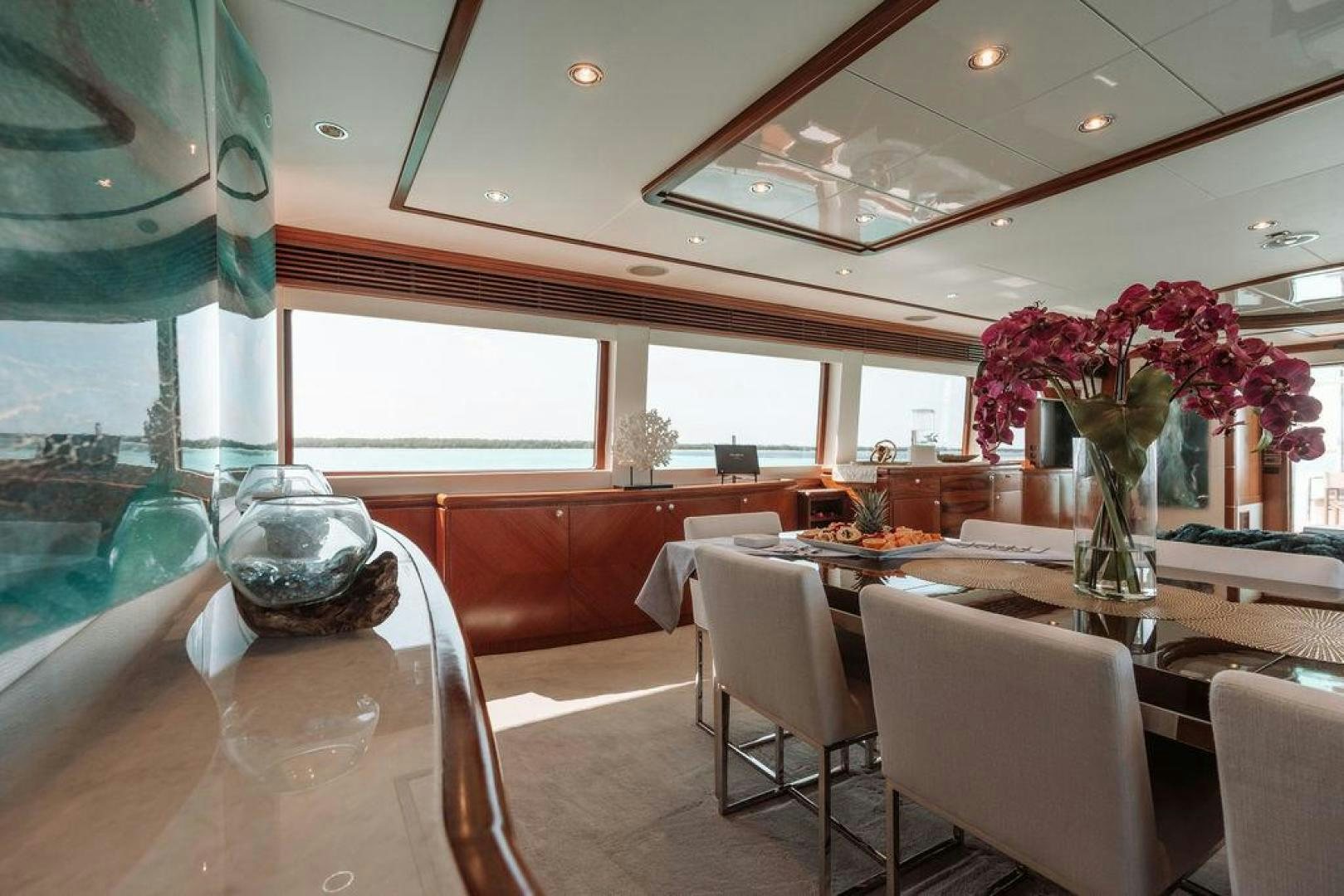 a dining room with a vase of flowers on a table aboard BEACHFRONT Yacht for Sale