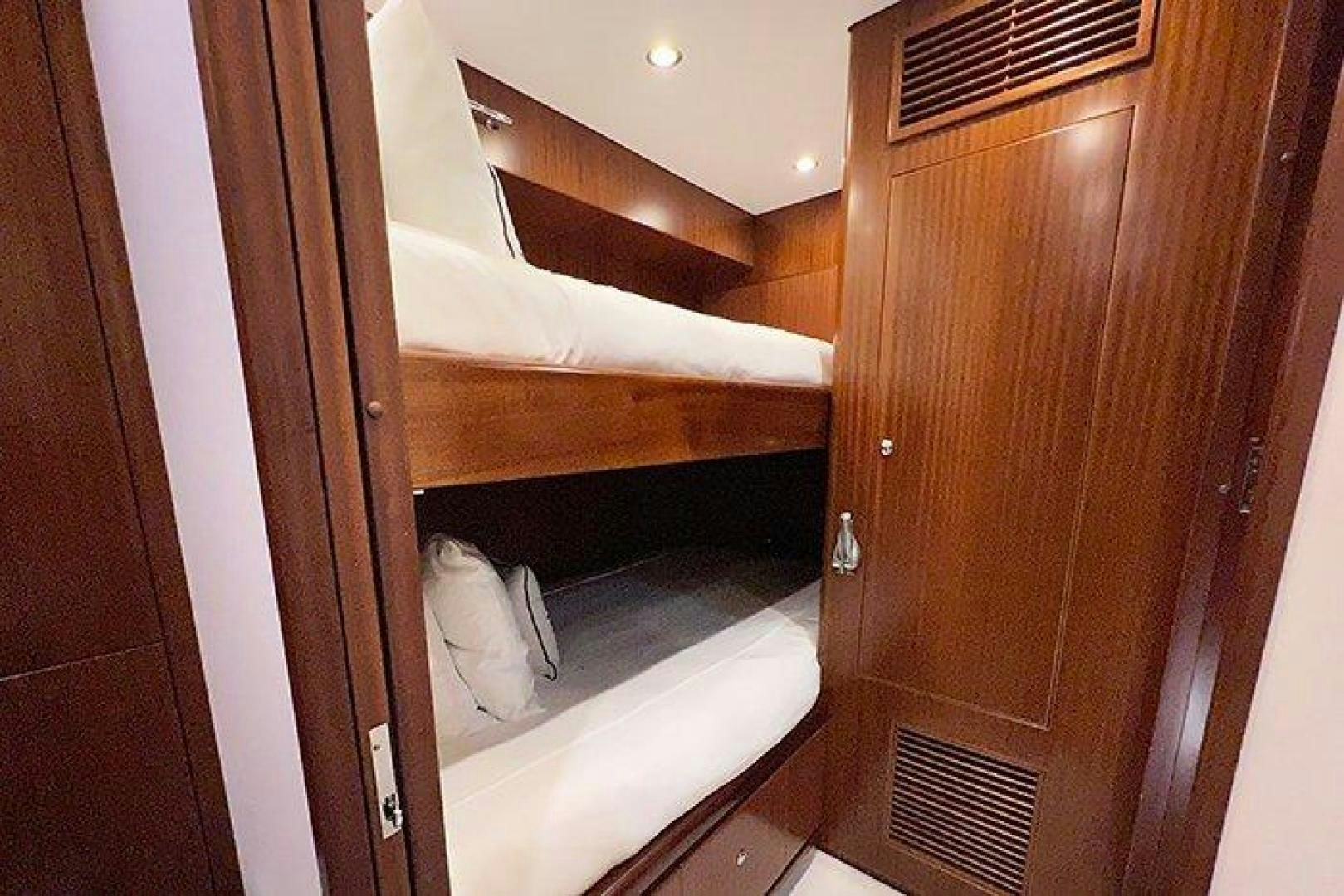 a white cat on a wooden staircase aboard BEACHFRONT Yacht for Sale