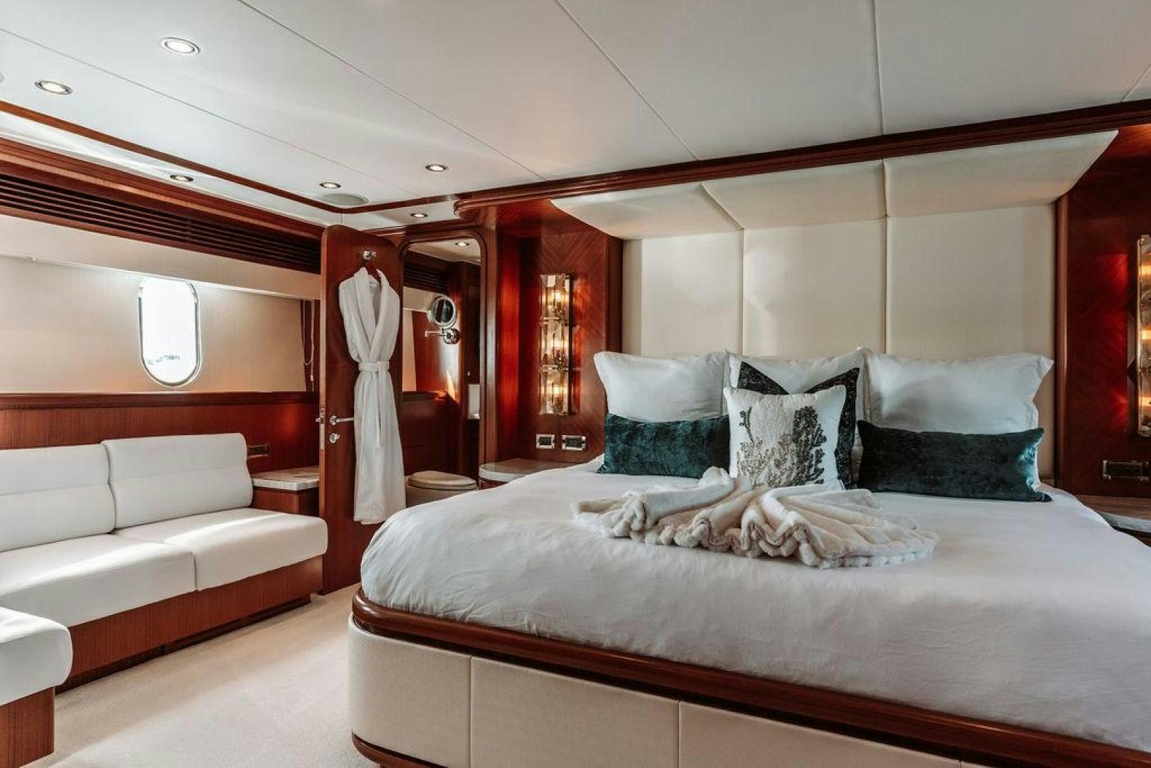 a room with a bed and a couch aboard BEACHFRONT Yacht for Sale