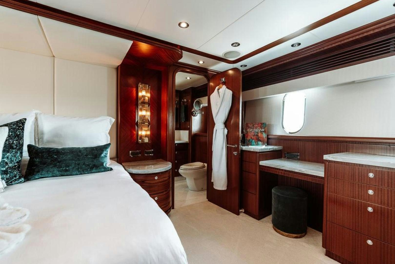 a room with a bed and a dresser aboard BEACHFRONT Yacht for Sale