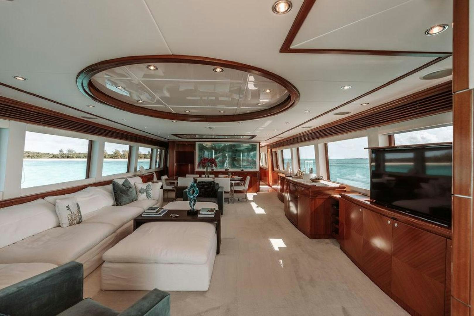 a large living room with a large chandelier aboard BEACHFRONT Yacht for Sale