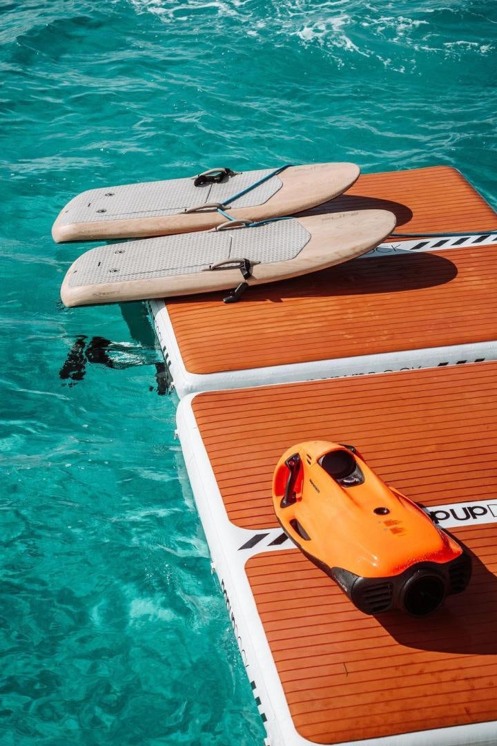 a yellow and white kayak on a river aboard BEACHFRONT Yacht for Sale
