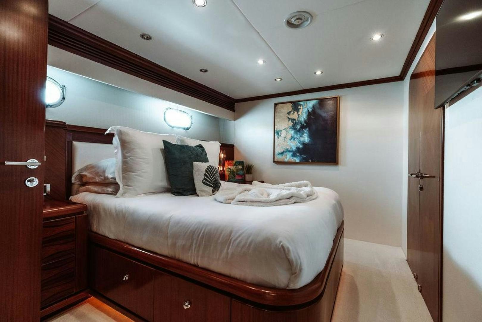 a bed with a white sheet and pillows on it aboard BEACHFRONT Yacht for Sale