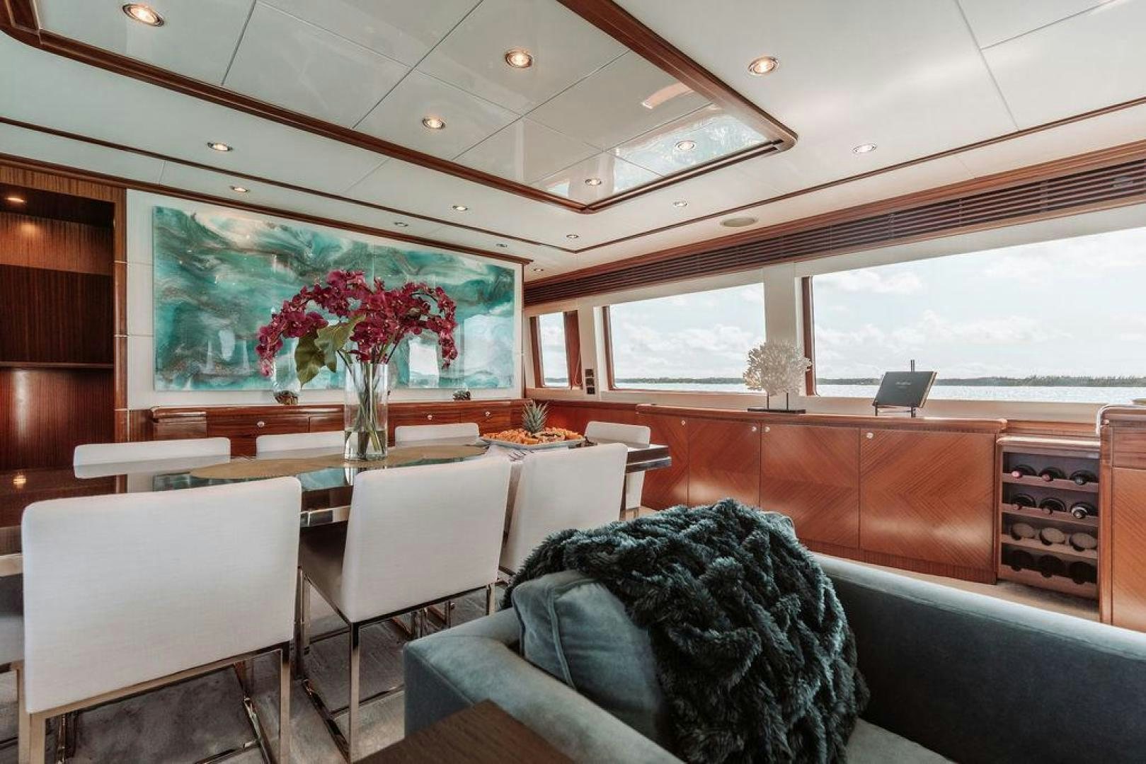 a room with a couch and a table and chairs aboard BEACHFRONT Yacht for Sale