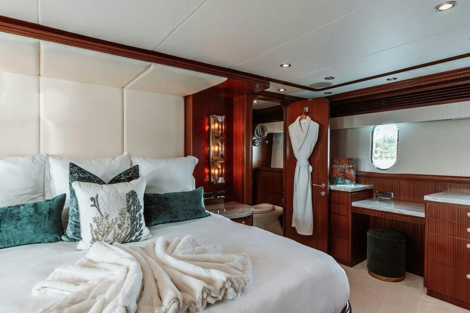 a bed with white sheets and pillows aboard BEACHFRONT Yacht for Sale