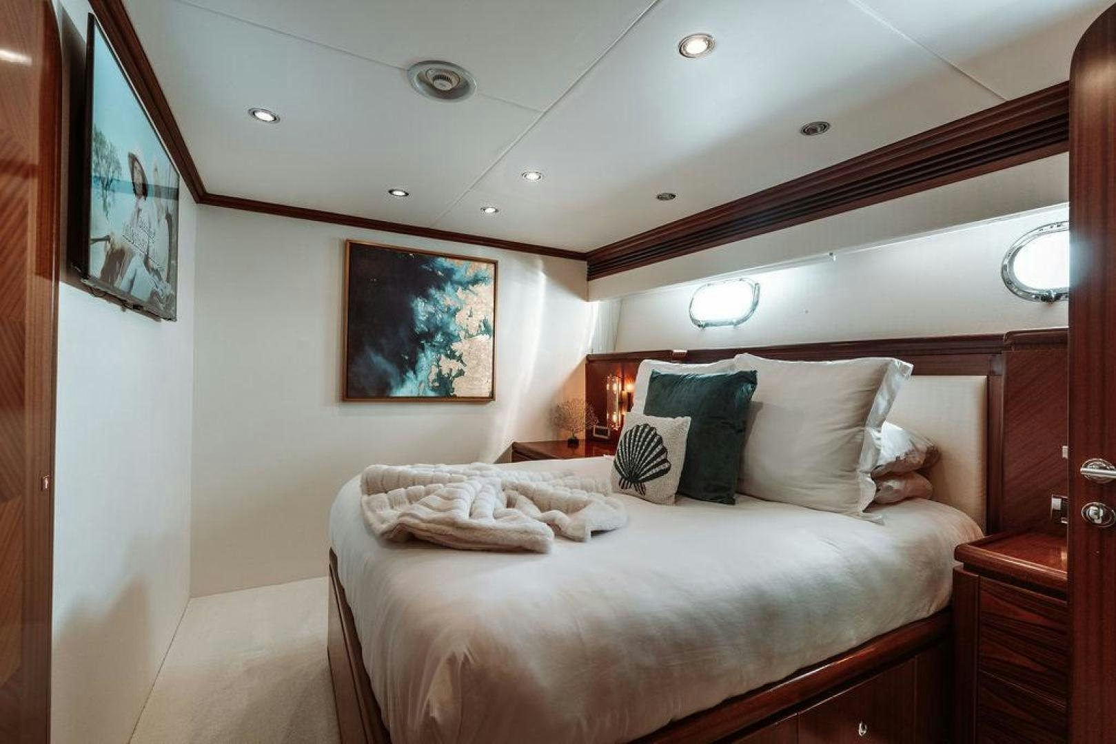 a bed with pillows on it aboard BEACHFRONT Yacht for Sale