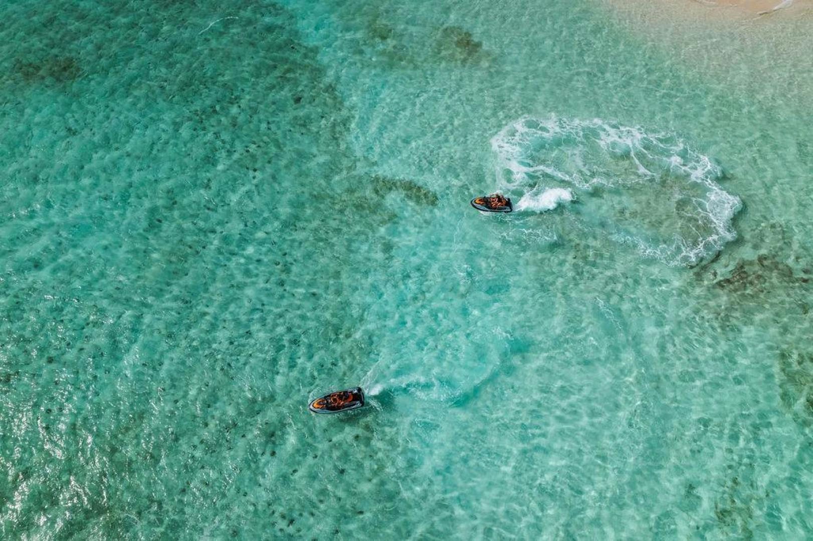 a couple of people swimming in the ocean aboard BEACHFRONT Yacht for Sale