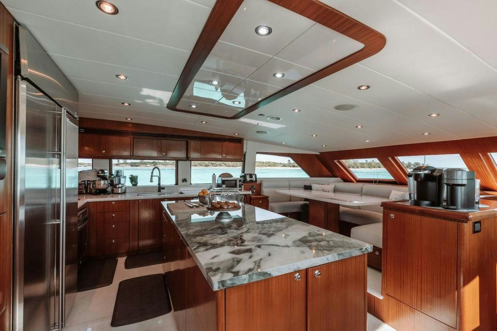a large kitchen with a large island aboard BEACHFRONT Yacht for Sale