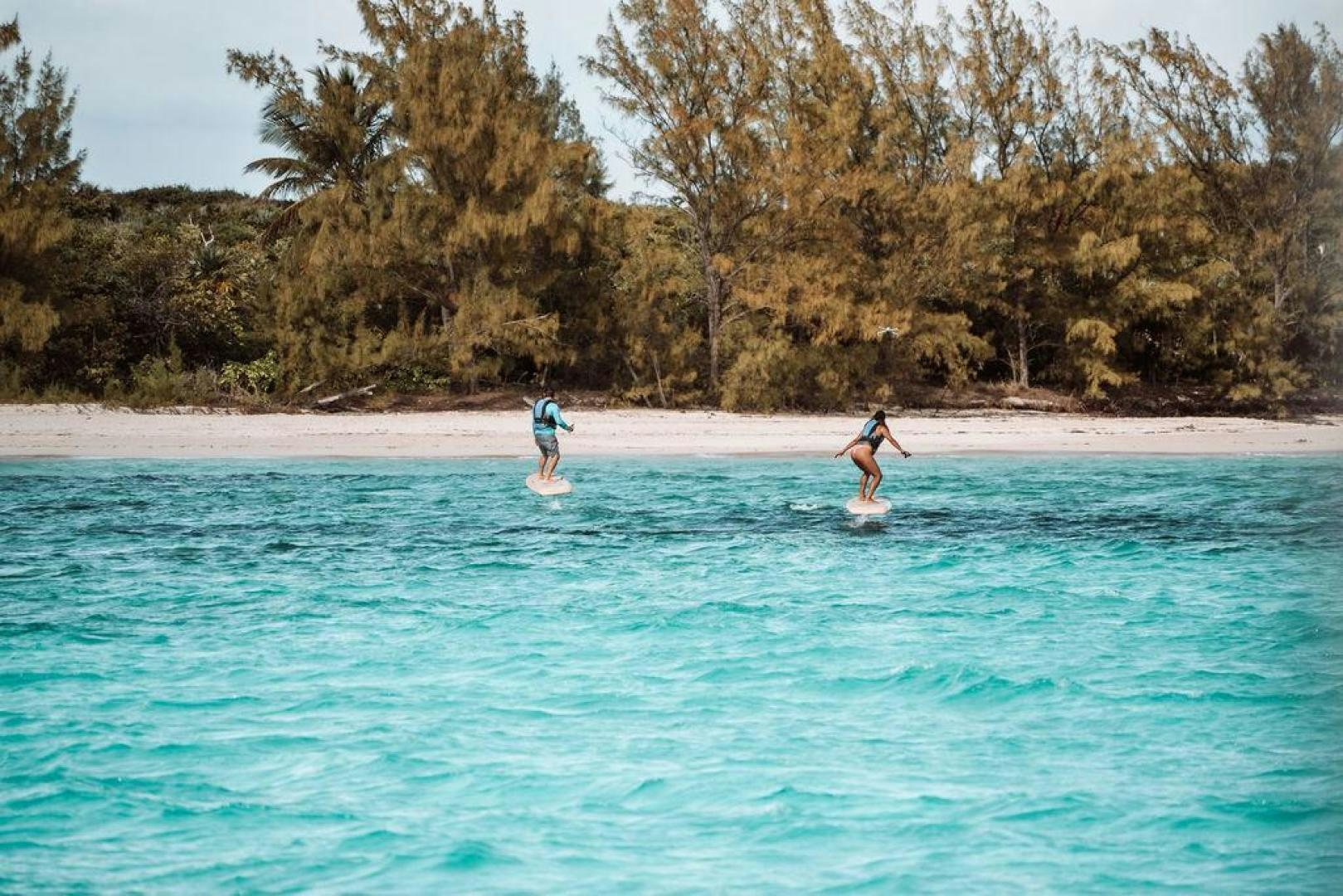 two people surfing in the sea aboard BEACHFRONT Yacht for Sale
