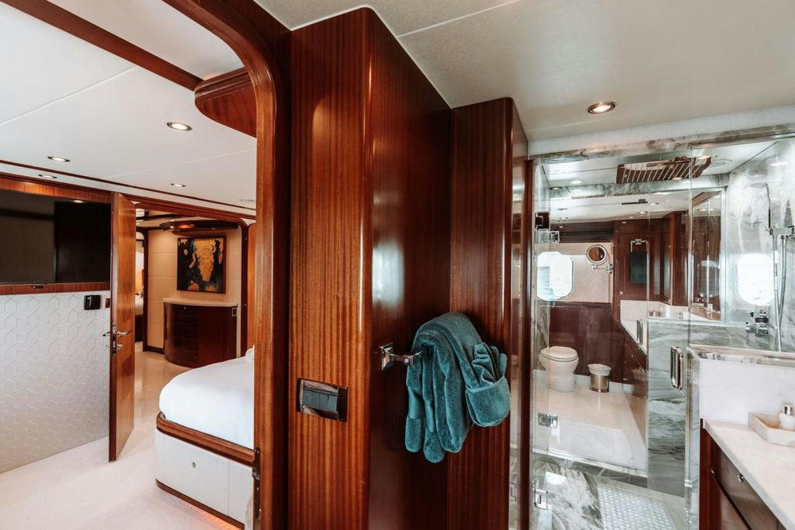 a bathroom with a wood door aboard BEACHFRONT Yacht for Sale