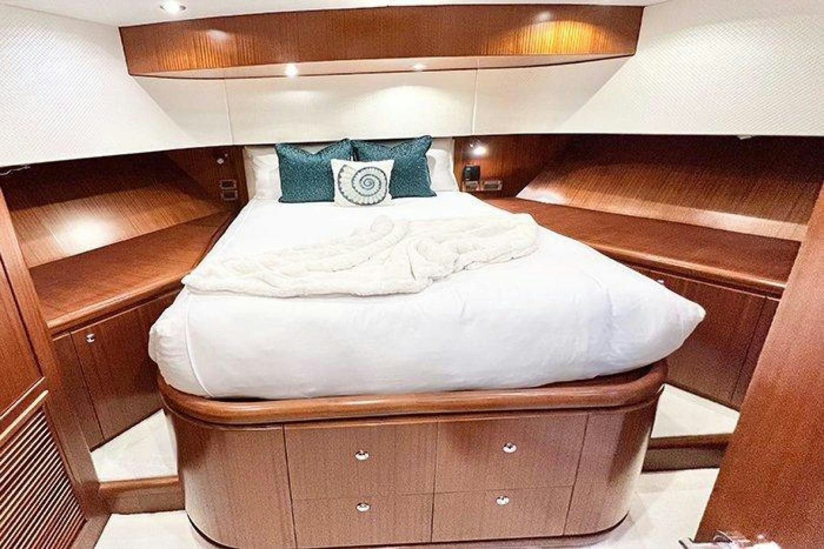 a bed with a white comforter aboard BEACHFRONT Yacht for Sale