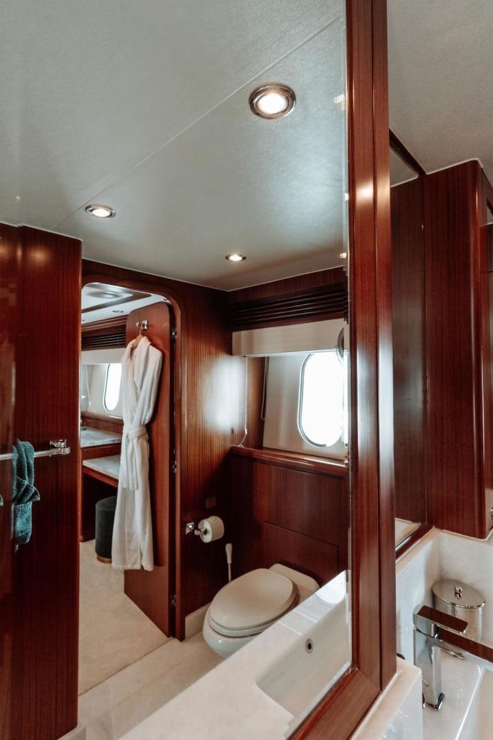 a bathroom with a toilet and bathtub aboard BEACHFRONT Yacht for Sale