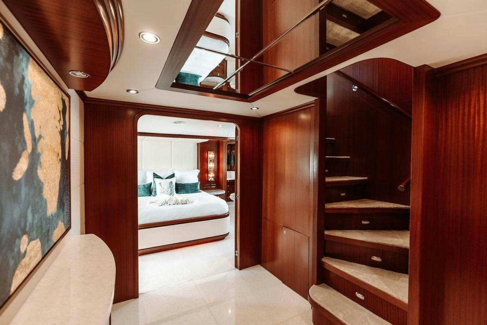 a room with a bed and a mirror aboard BEACHFRONT Yacht for Sale