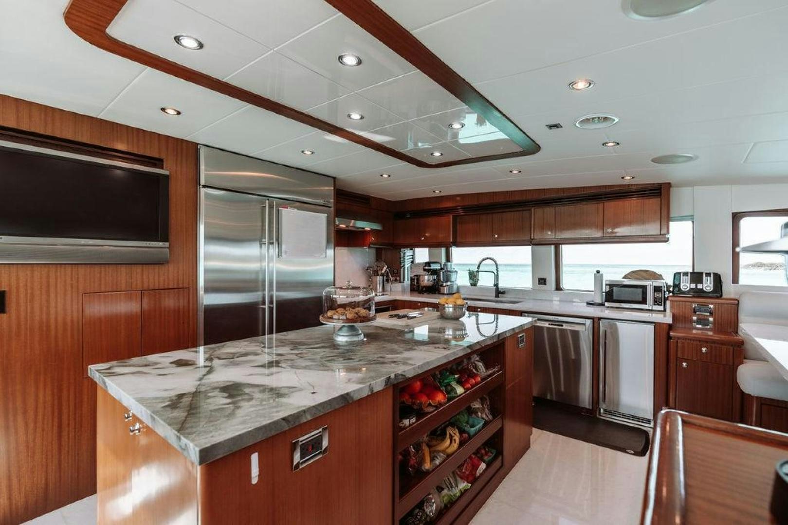 a kitchen with a bar and a bar aboard BEACHFRONT Yacht for Sale