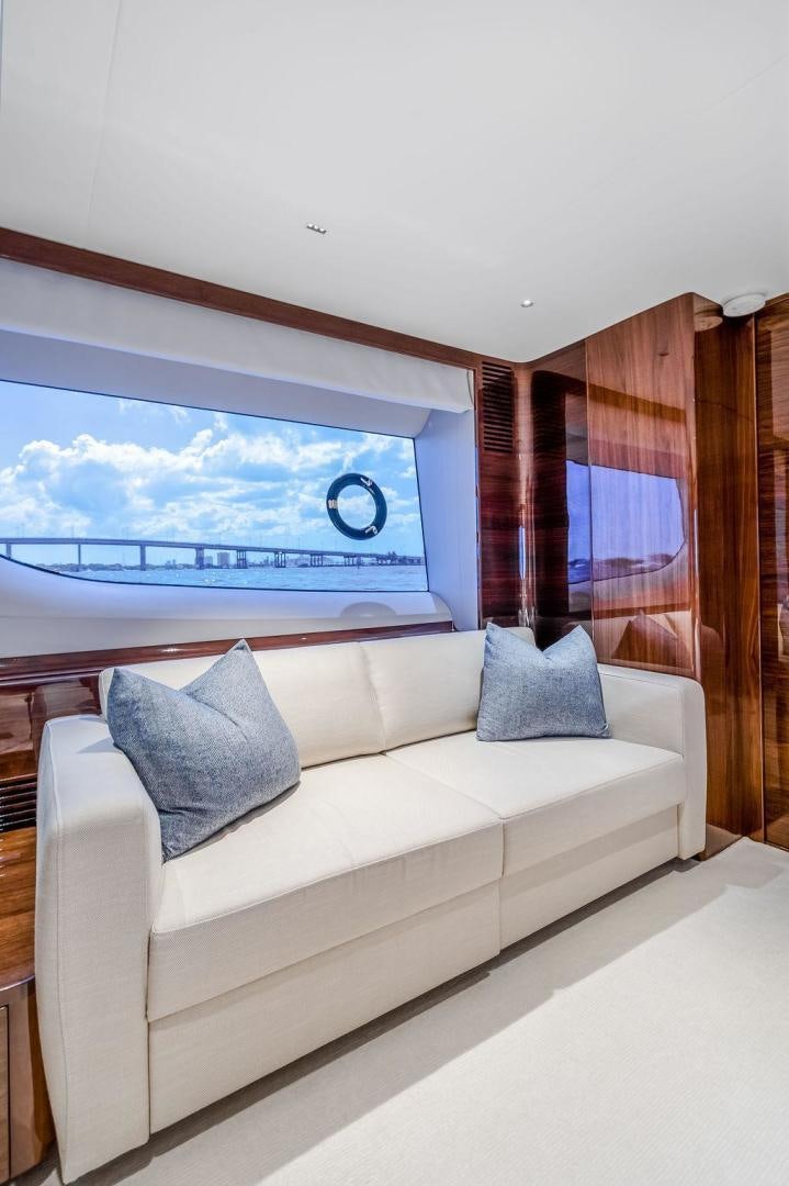 a bed with a window and a view of the water aboard HIDEOUT Yacht for Sale