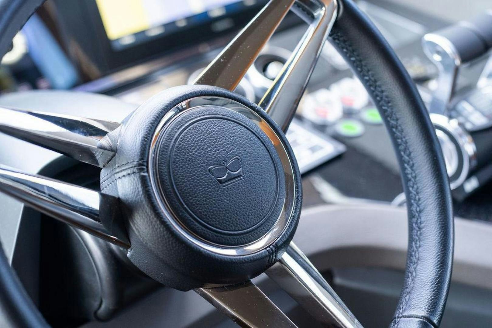 a steering wheel and dashboard of a car aboard HIDEOUT Yacht for Sale