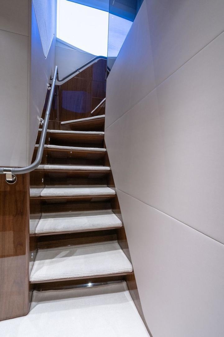 a staircase with a metal railing aboard HIDEOUT Yacht for Sale