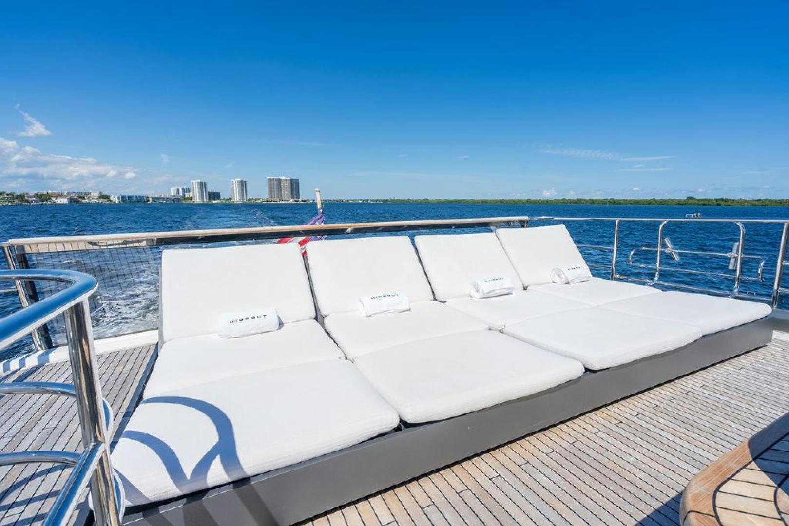 a deck with a view of a city and water aboard HIDEOUT Yacht for Sale