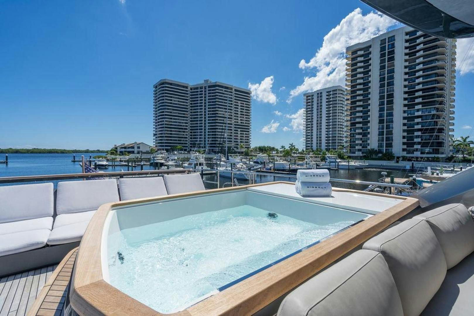 a pool with a city in the background aboard HIDEOUT Yacht for Sale