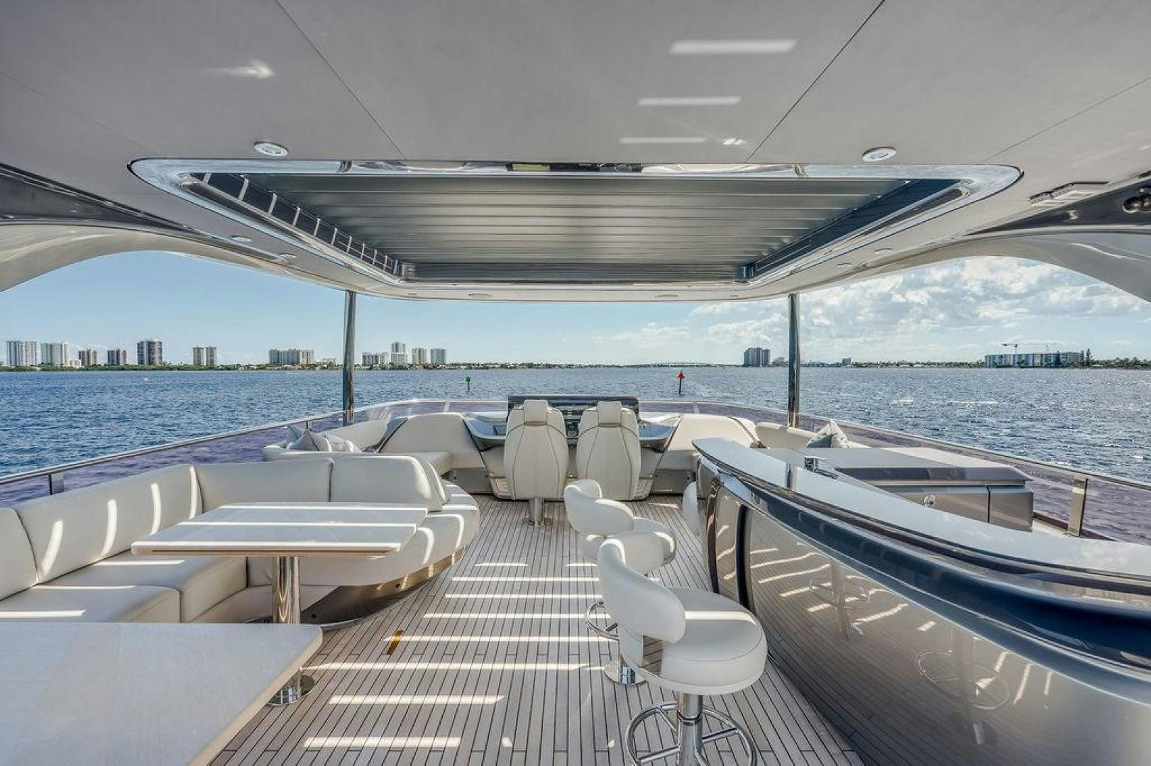 a deck with chairs and tables on it aboard HIDEOUT Yacht for Sale