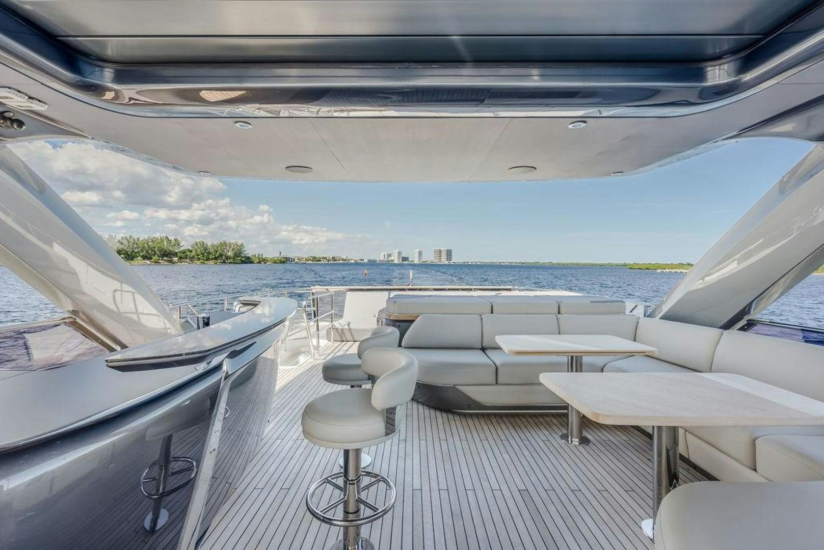 a deck with a view of the ocean and a city aboard HIDEOUT Yacht for Sale