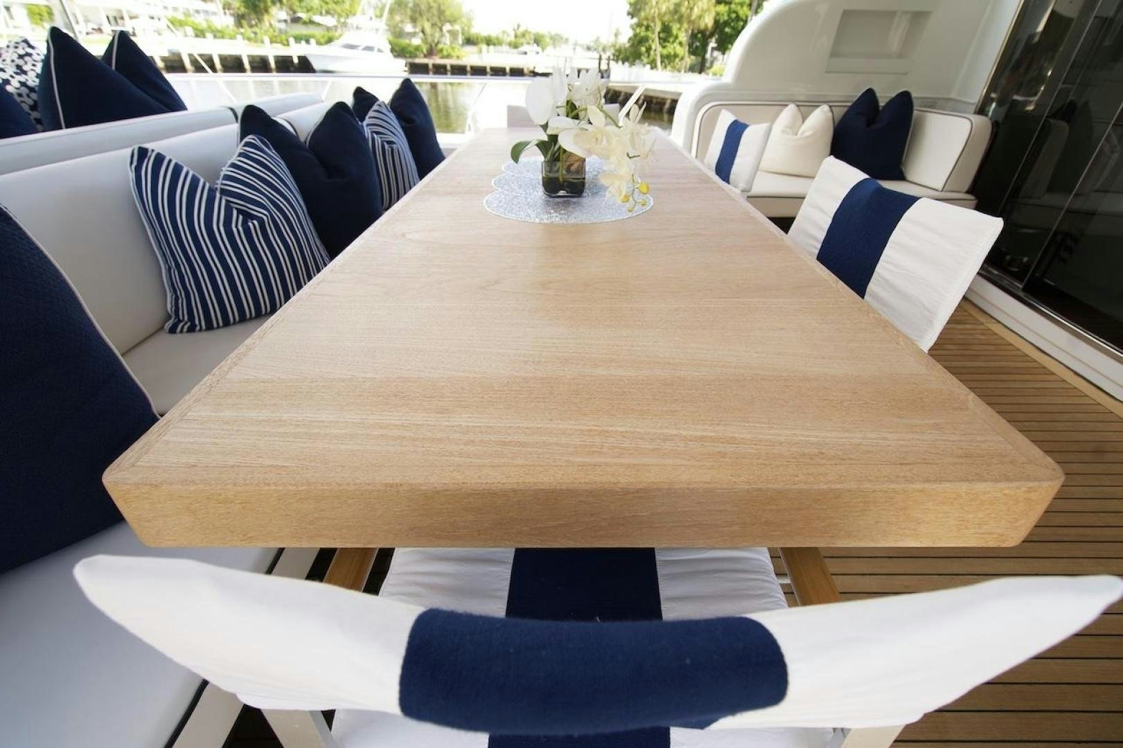 a table with chairs and a plant on it aboard U WISH Yacht for Sale