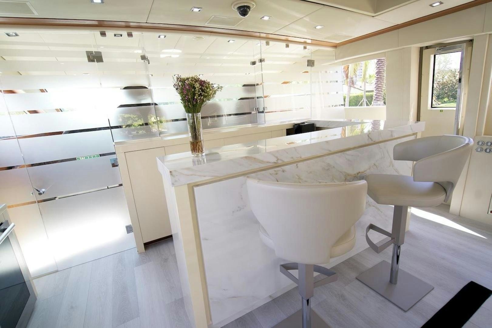 a white table with chairs aboard U WISH Yacht for Sale