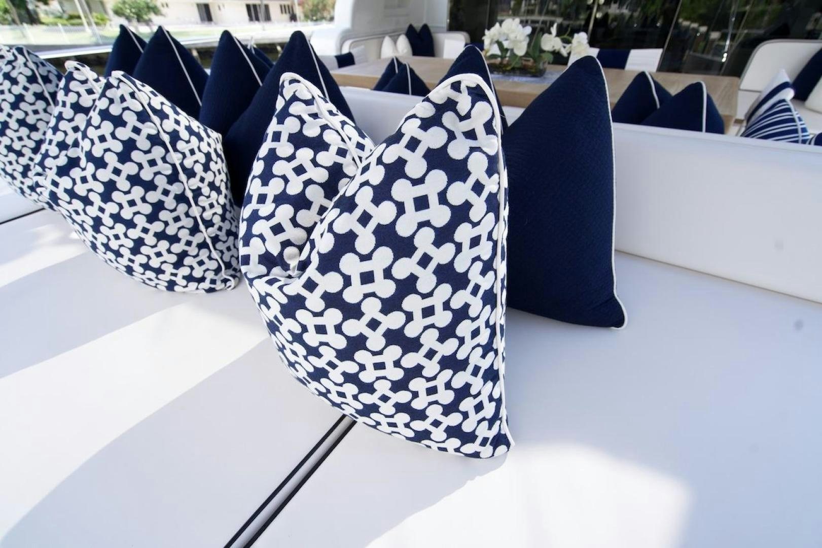 a group of black and white umbrellas on a table aboard U WISH Yacht for Sale