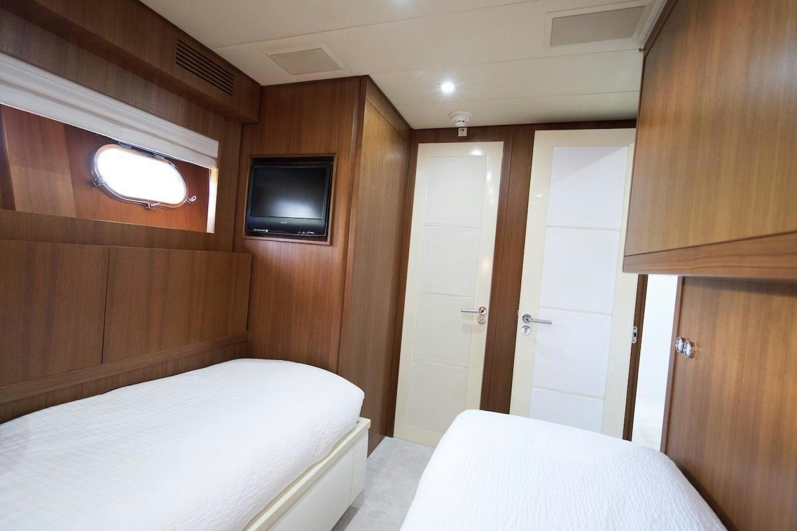 a room with a television and a bed aboard U WISH Yacht for Sale