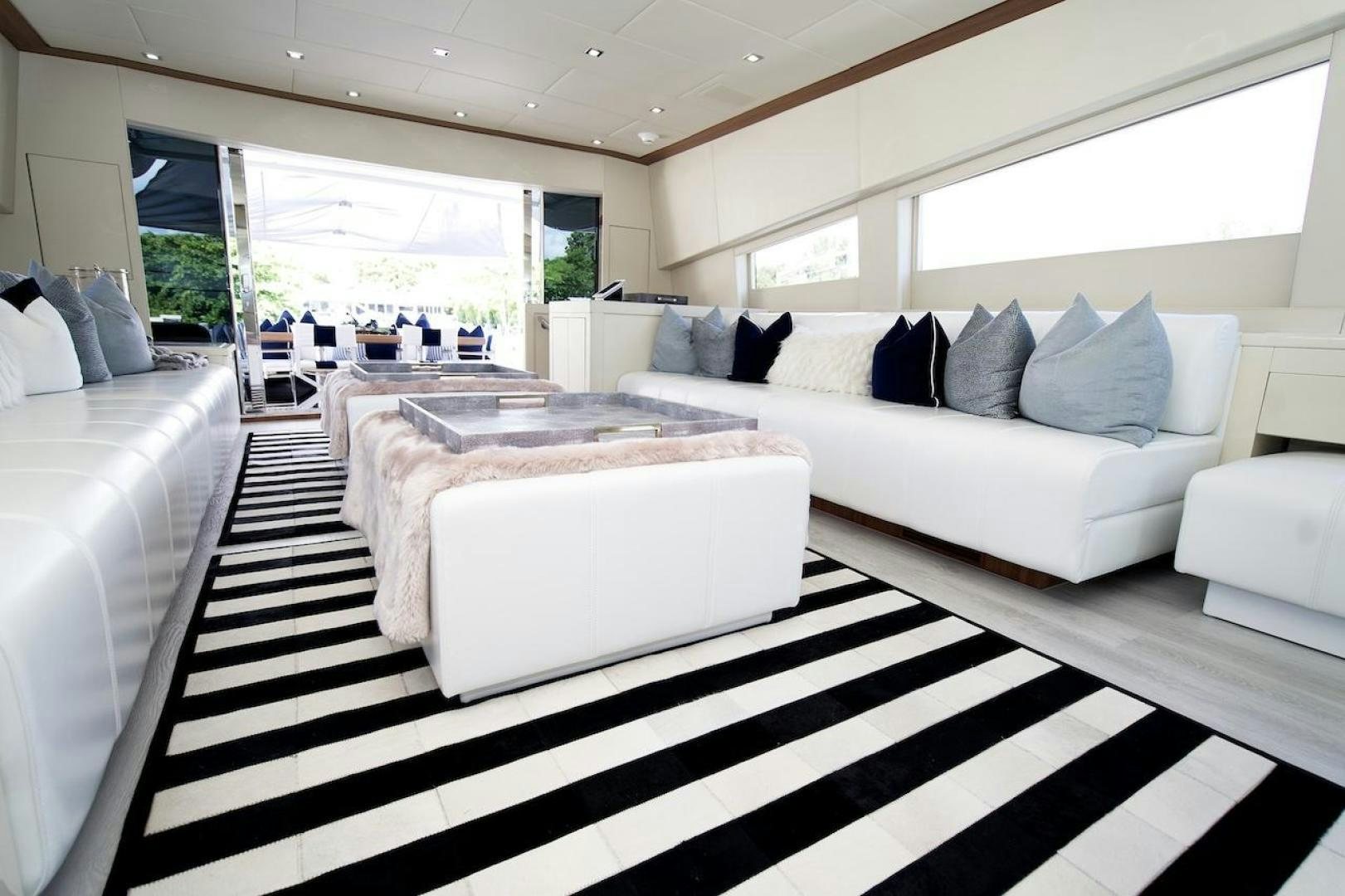 a white living room with black and white checkered flooring aboard U WISH Yacht for Sale