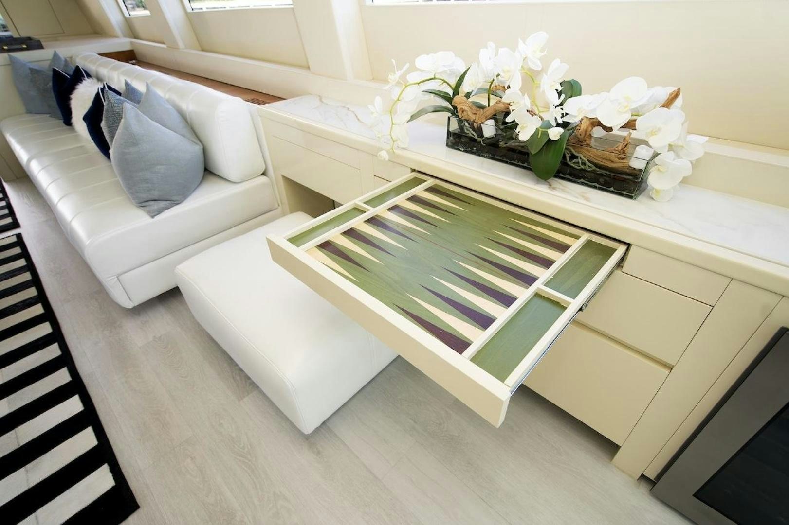 a glass coffee table with white cushions aboard U WISH Yacht for Sale