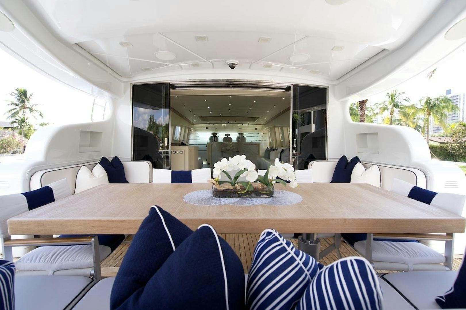a dining table with chairs and a planter on it aboard U WISH Yacht for Sale