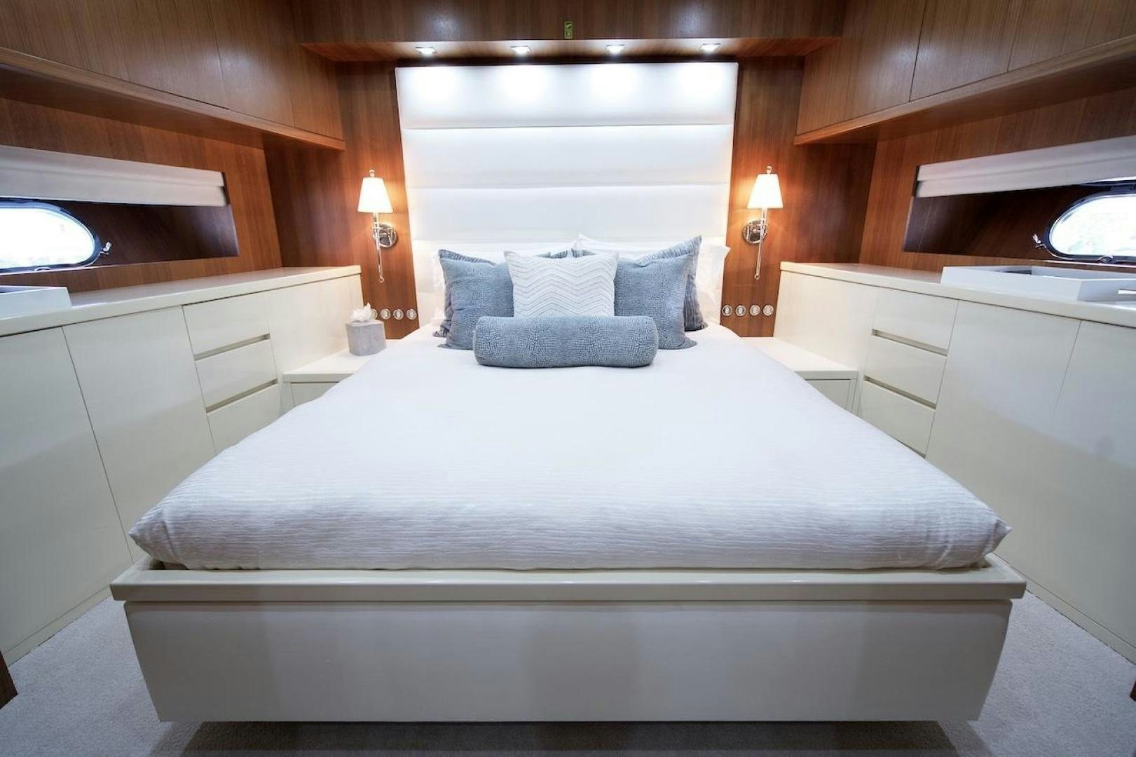 a bed with a white sheet and pillows on it aboard U WISH Yacht for Sale