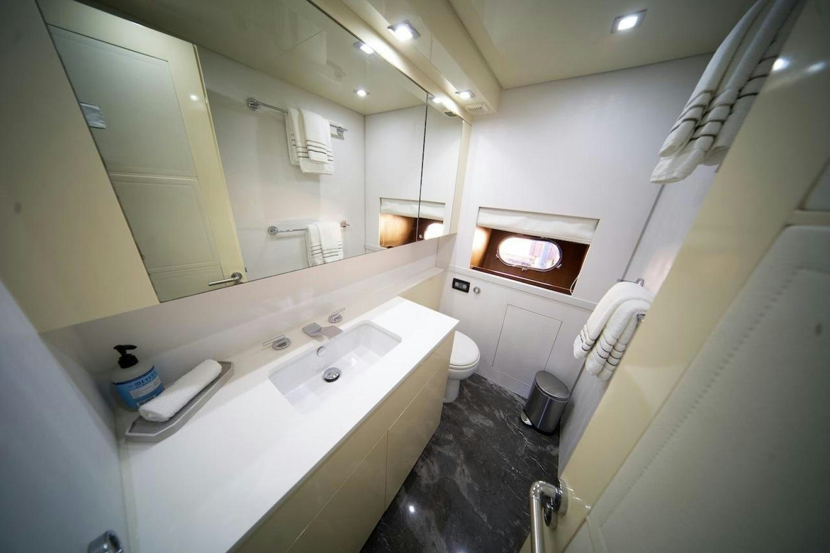 a bathroom with a large mirror aboard U WISH Yacht for Sale
