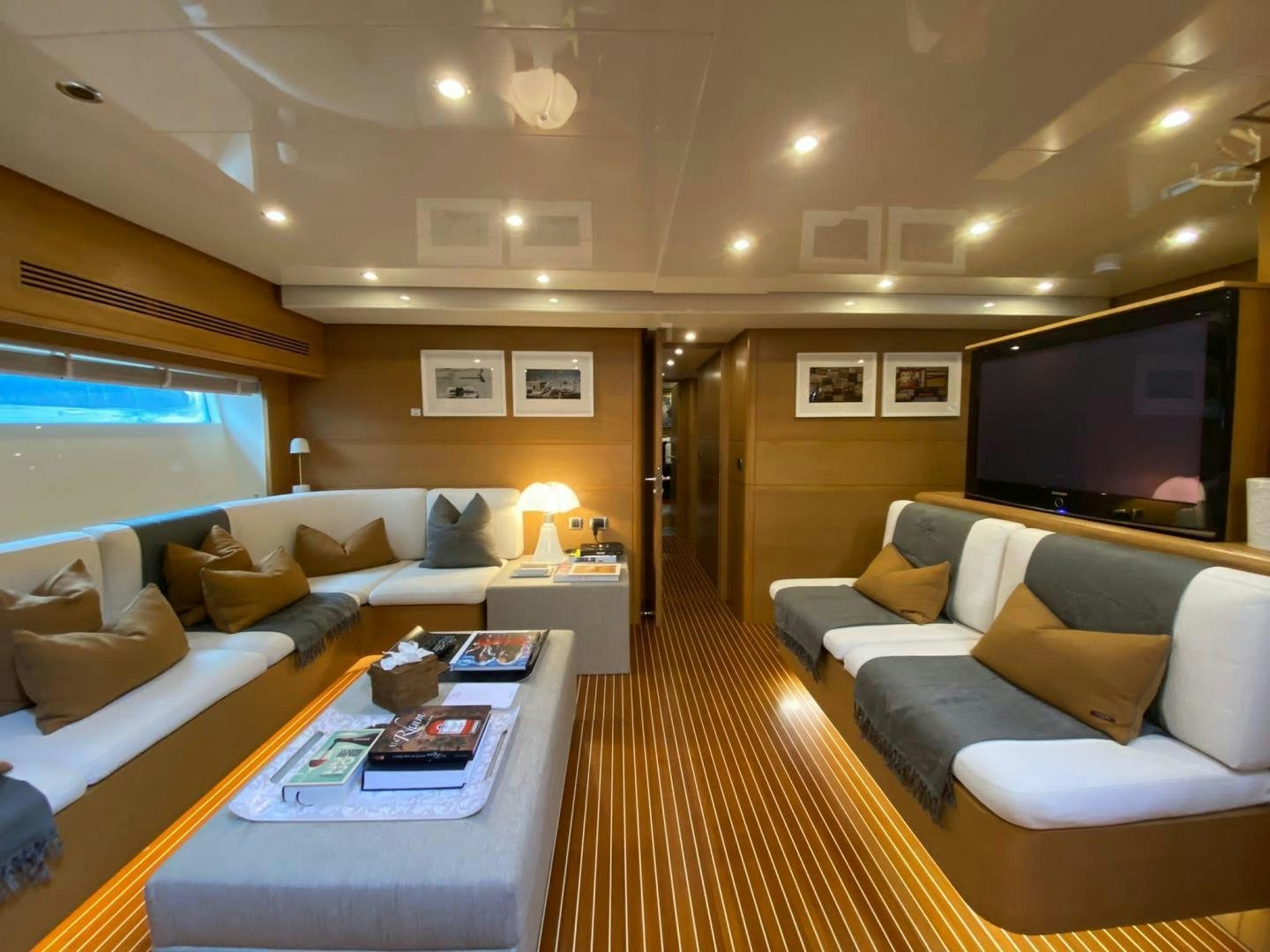 a living room with a large screen aboard MOKI Yacht for Sale
