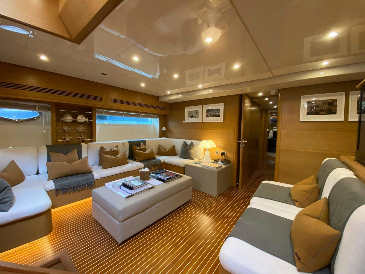 a living room with a large window aboard MOKI Yacht for Sale