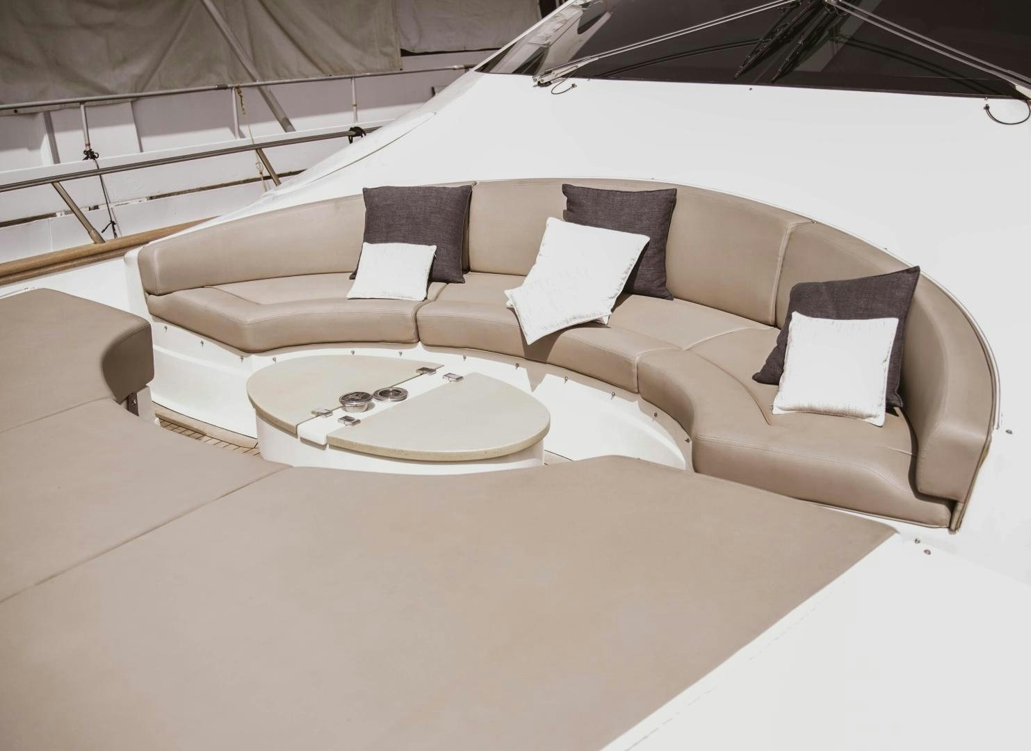 a couch with a table and chairs aboard MOKI Yacht for Sale