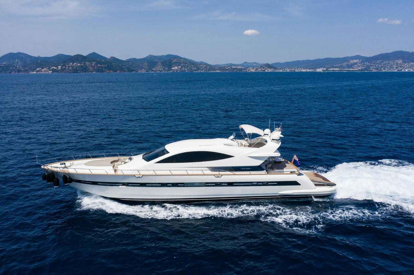 a white boat on the water aboard MOKI Yacht for Sale