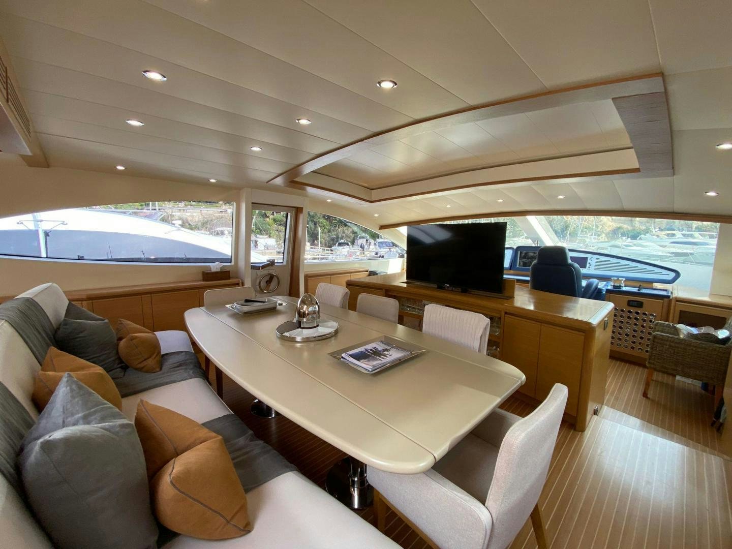 a room with a table chairs and a couch aboard MOKI Yacht for Sale