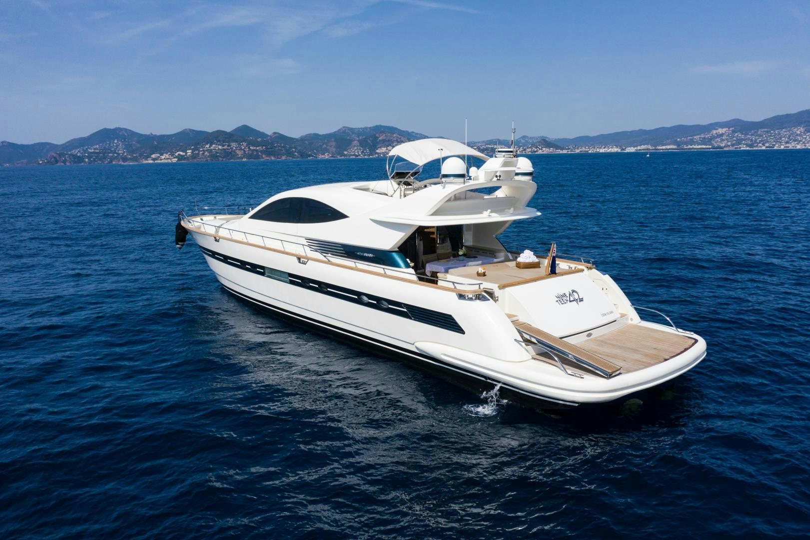 a white yacht in the water aboard MOKI Yacht for Sale