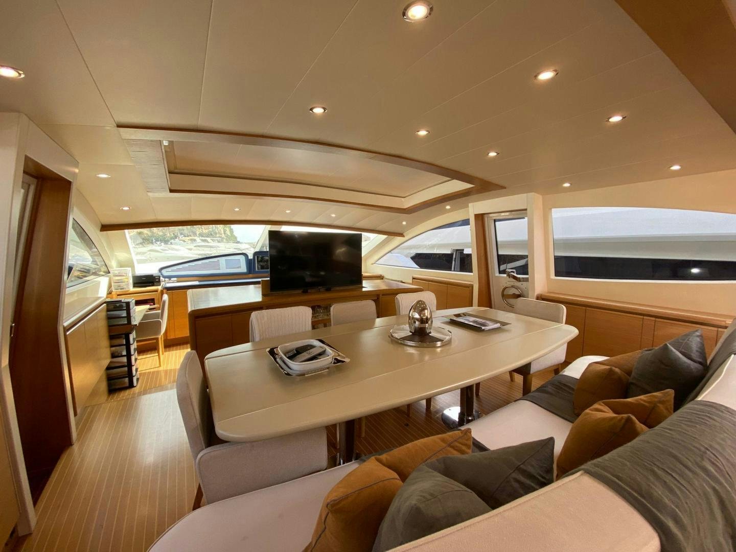 a living room with a large table aboard MOKI Yacht for Sale