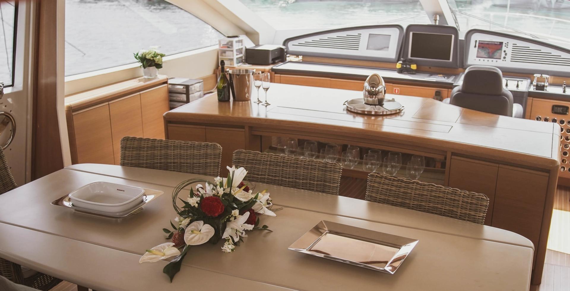 a table with a vase and a plate with flowers on it aboard MOKI Yacht for Sale