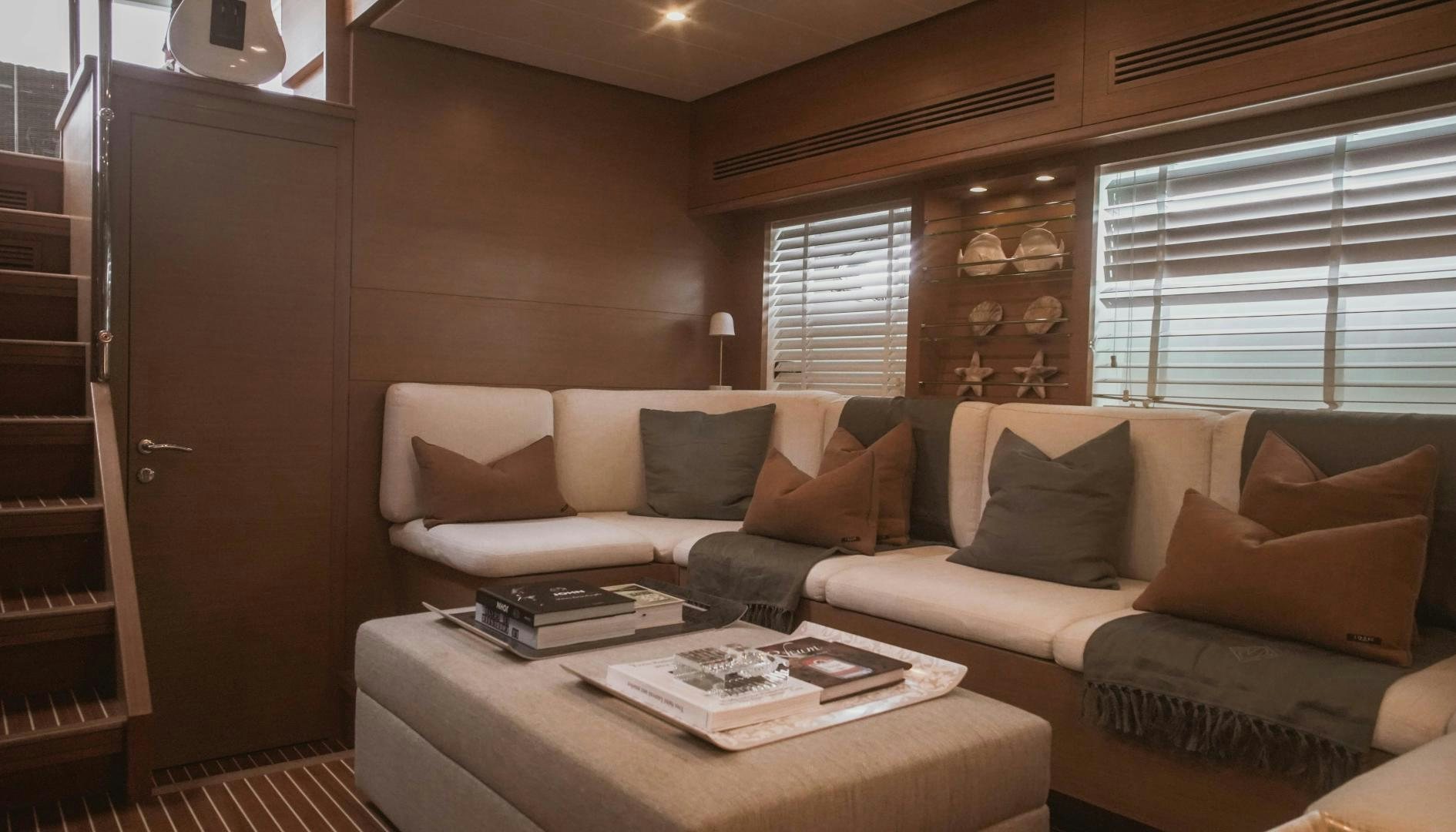 a living room with a couch and a coffee table aboard MOKI Yacht for Sale